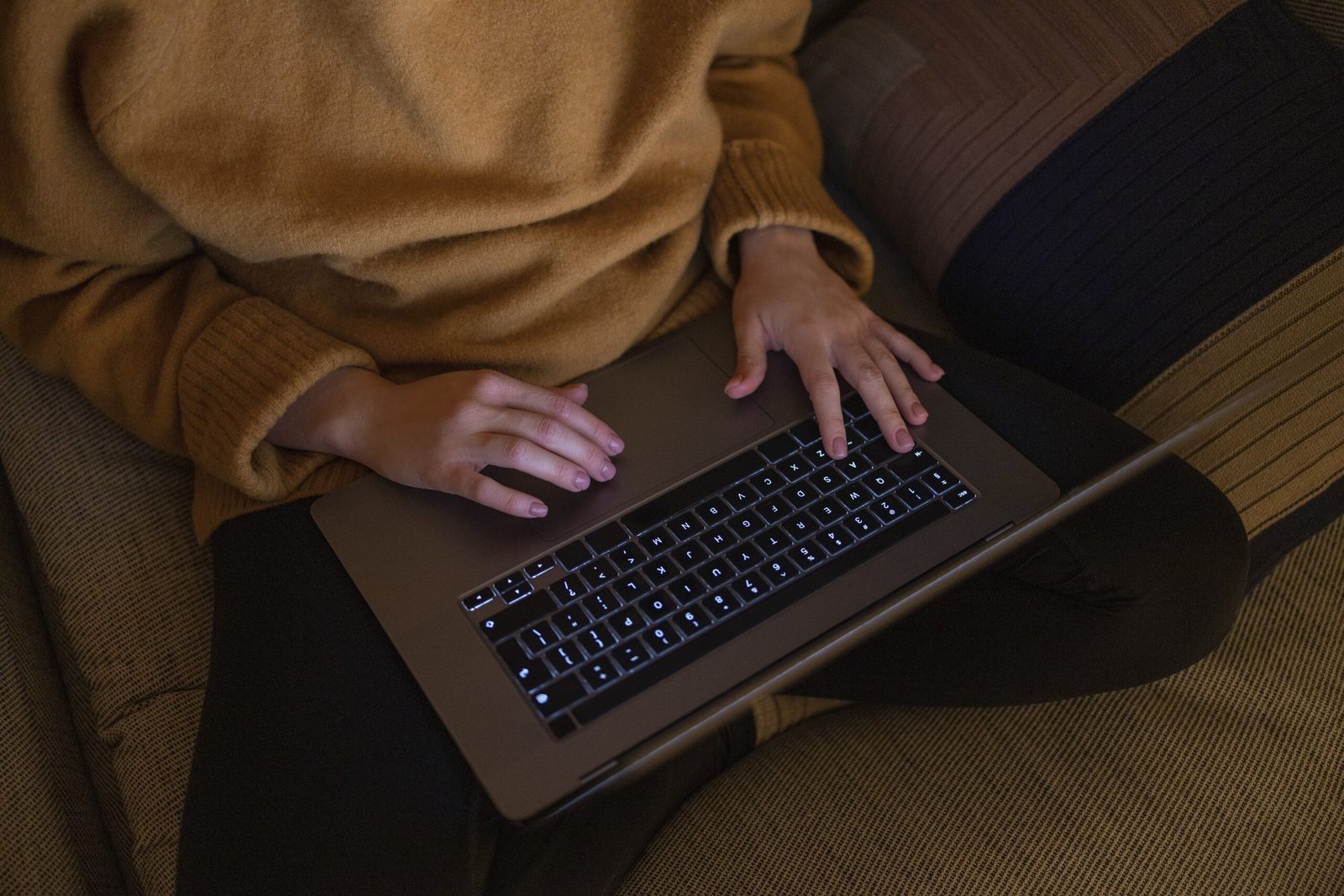 Person typing a creative interactive story prompt into an AI chatbot on a laptop