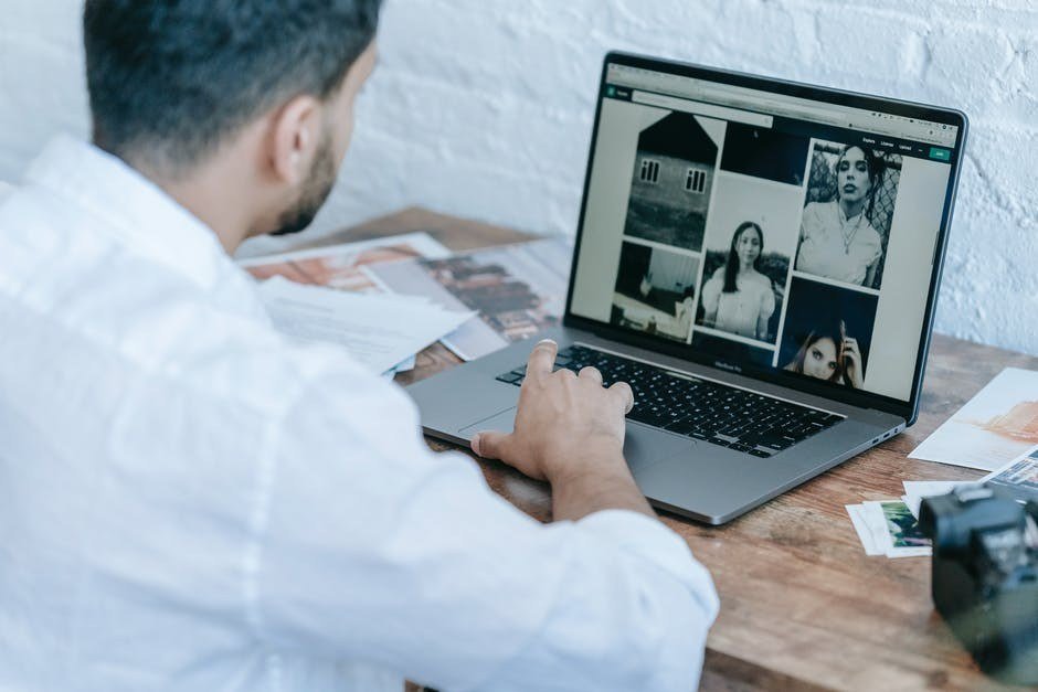 Person editing photos on a computer with AI tools