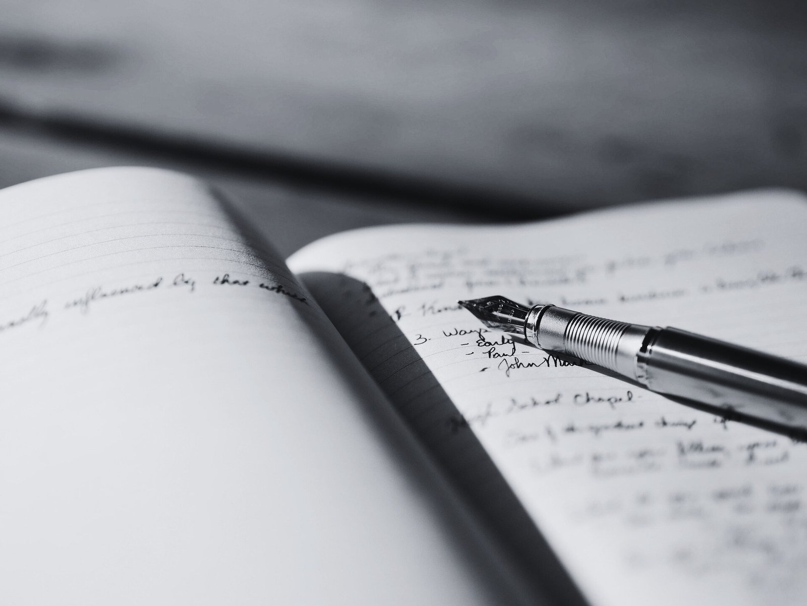 Handwritten notes in a notebook with pen showing AI note-taking concepts