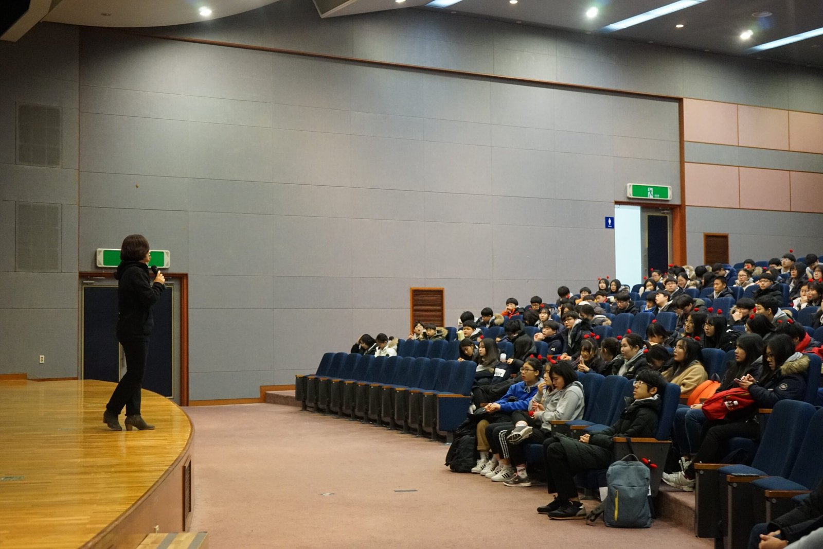 Conference audience watching a business presentation on stage
