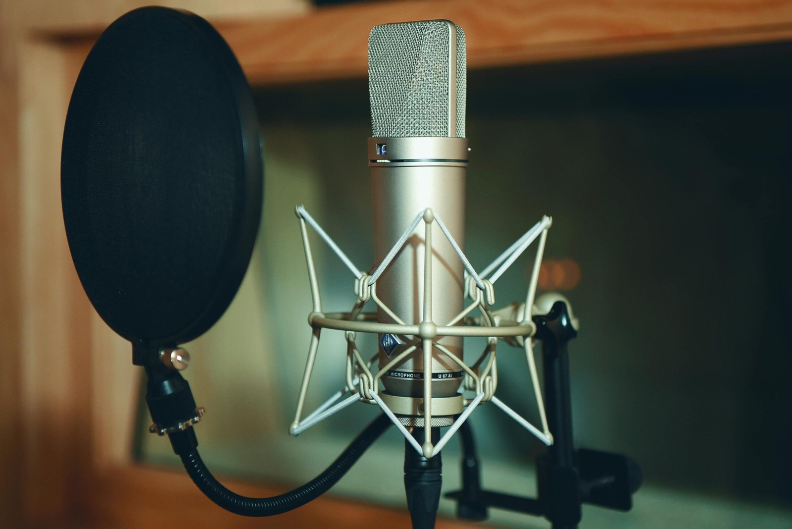 Close-up of a professional microphone with pop filter in a podcast studio