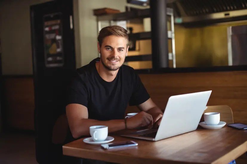 Entrepreneur running a small business from a laptop at a cafe
