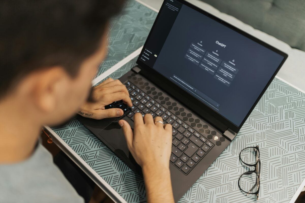 ChatGPT interface on a laptop screen in a modern workspace