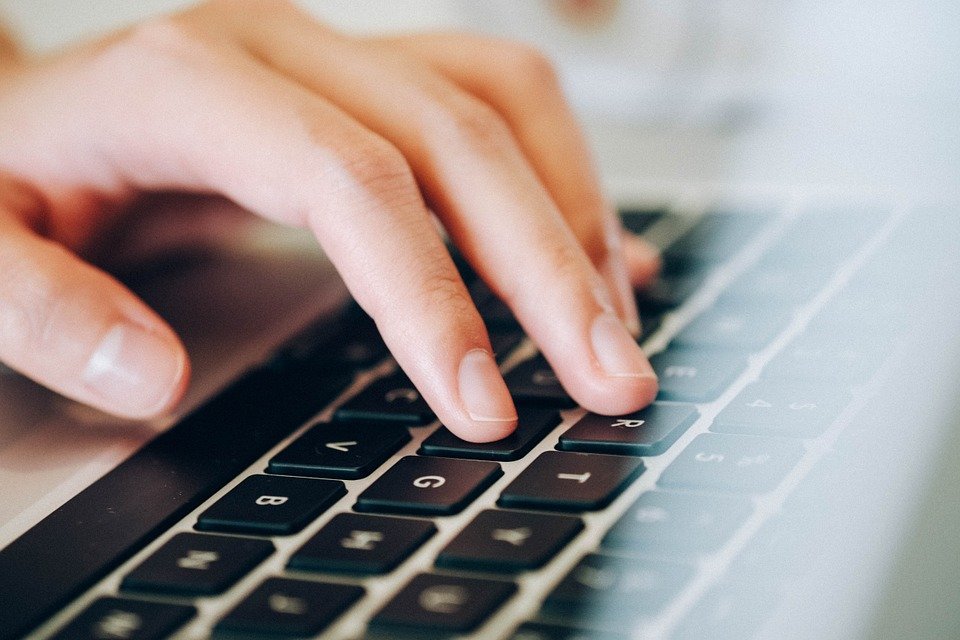 Closeup of hands typing on keyboard